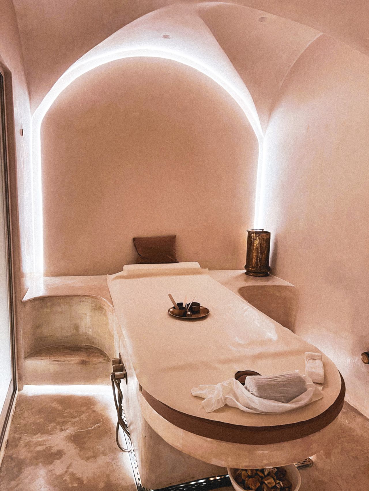 Massage table with beige linens